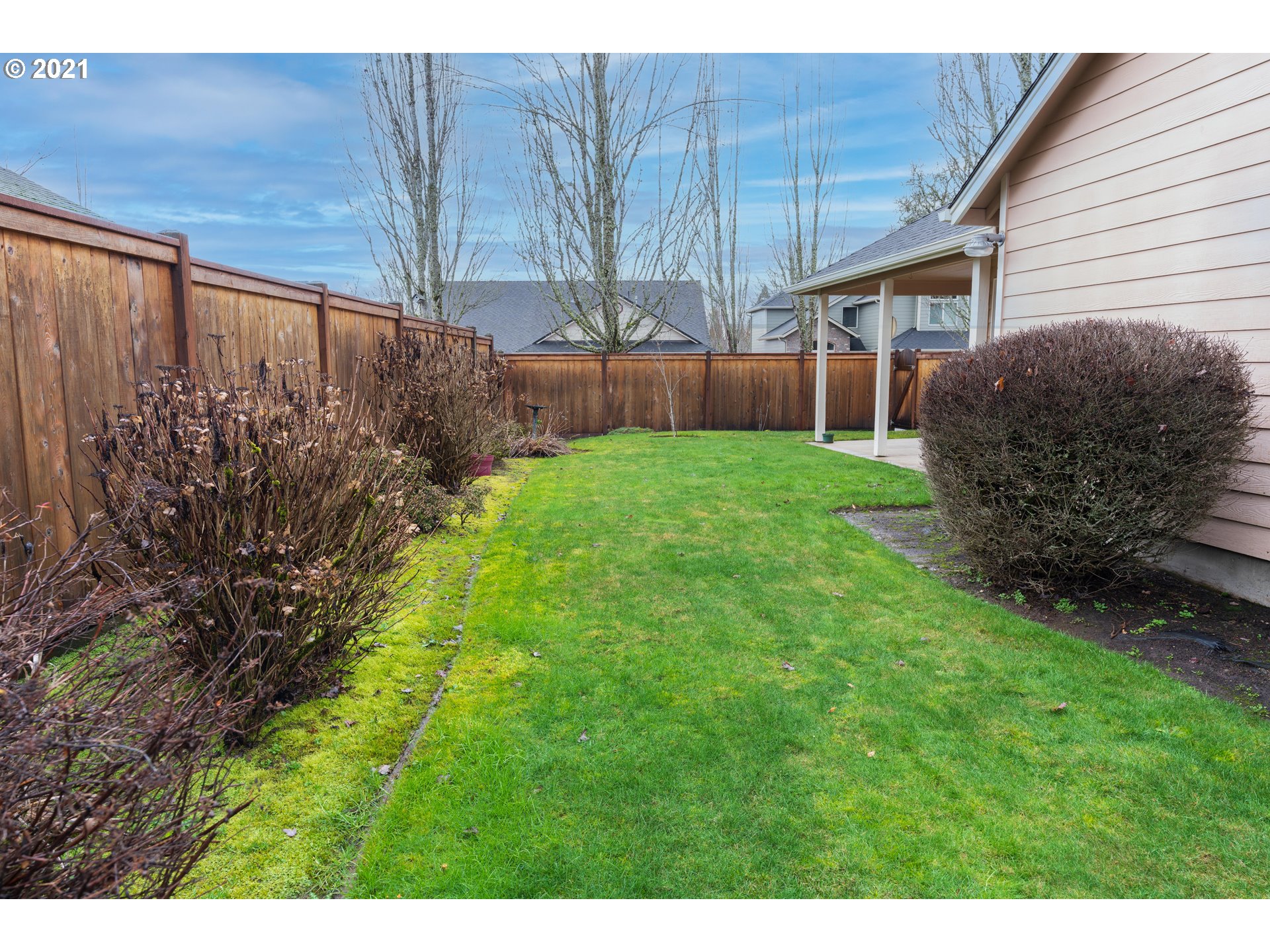 3305 Falcon Drive Springfield, OR 97477 - Photo 25 of 26 a view of backyard with potted plants and a wooden fence