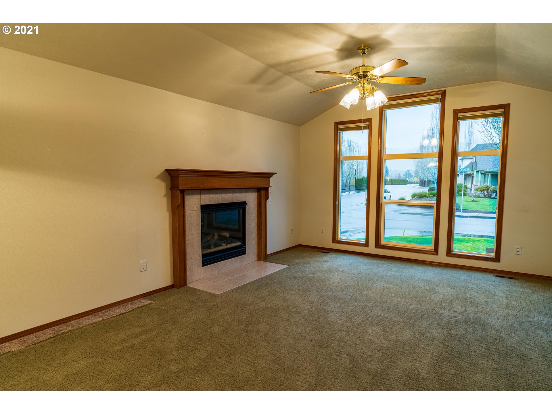 3305 Falcon Drive Springfield, OR 97477 - Photo 6 of 26 a view of an empty room with a fireplace and a window