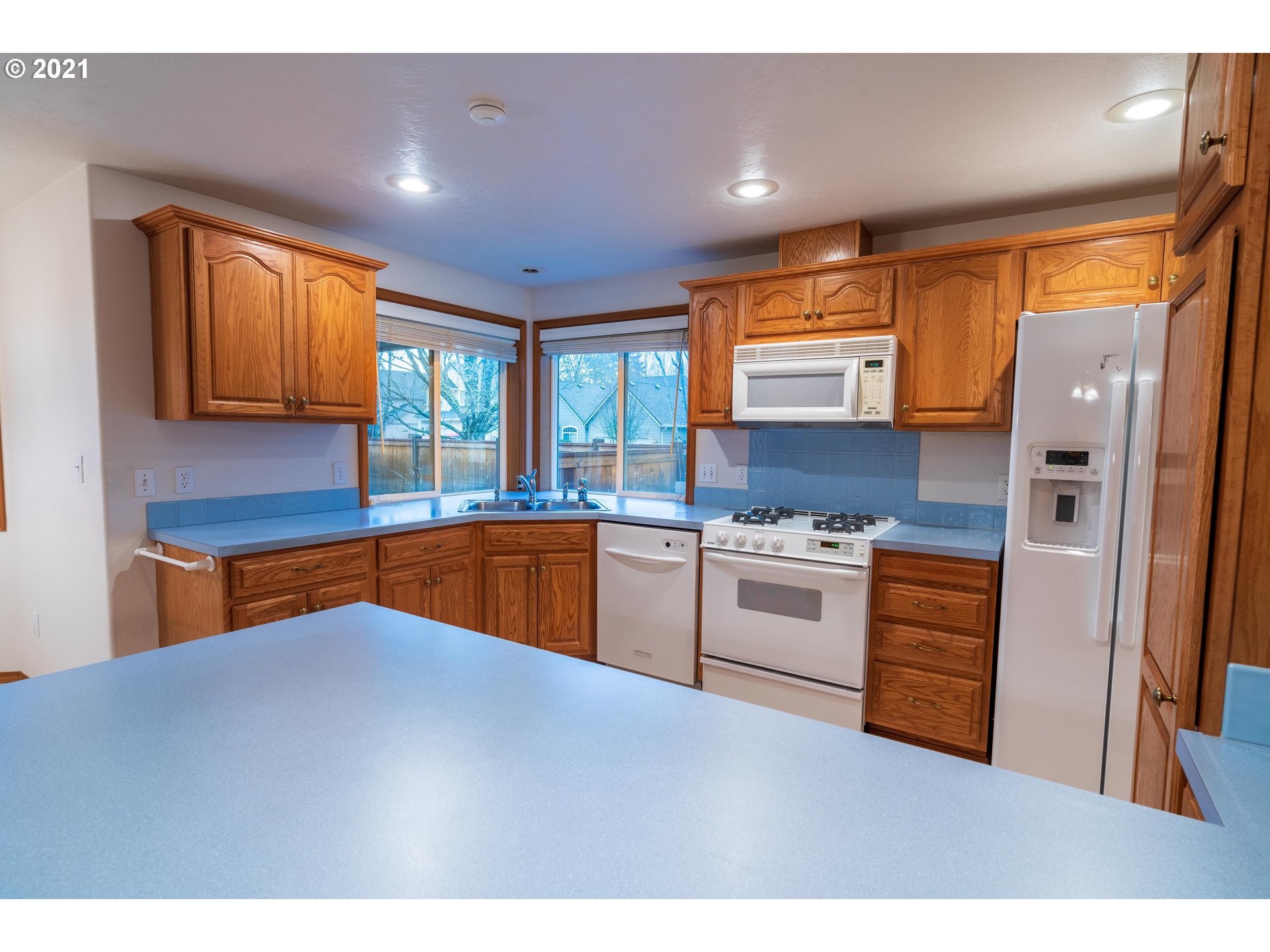 3305 Falcon Drive Springfield, OR 97477 - Photo 8 of 26 a kitchen with stainless steel appliances granite countertop a stove a sink and a refrigerator