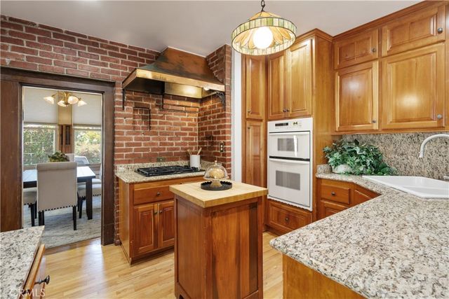 a kitchen with stainless steel appliances granite countertop a stove and a refrigerator