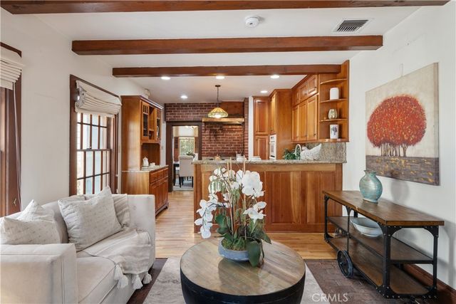 a living room with furniture a lamp and a potted plant