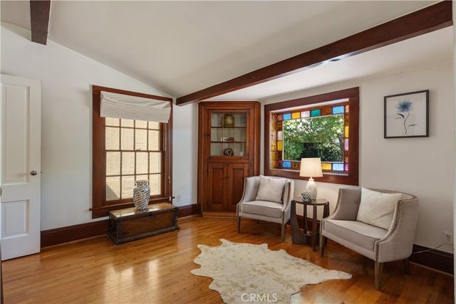 a bedroom with a bed lamp and a chandelier