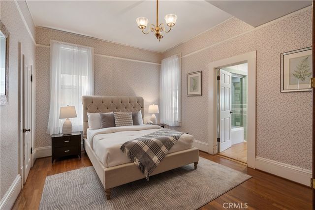 a en suite bathroom with a granite countertop sink and a mirror
