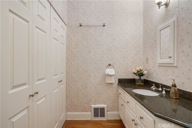 an empty room with wooden floor and window