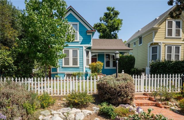 a kitchen with granite countertop white cabinets and stainless steel appliances