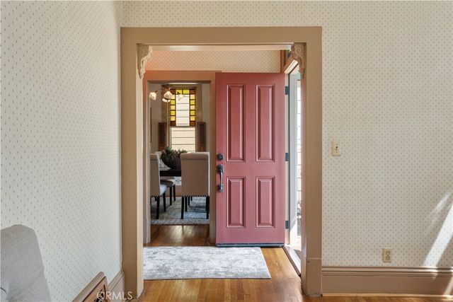 a view of a hallway with wooden floor windows and a livingroom
