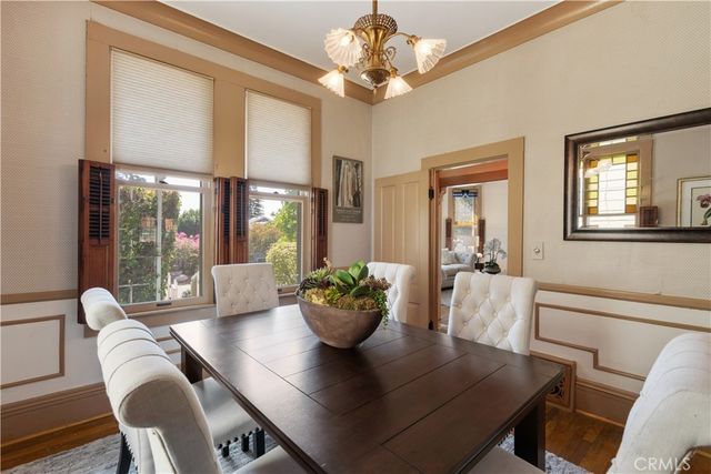 a view of a dining room with furniture wooden floor and chandelier