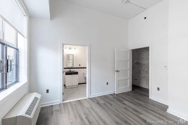 a view of a livingroom with wooden floor and windows