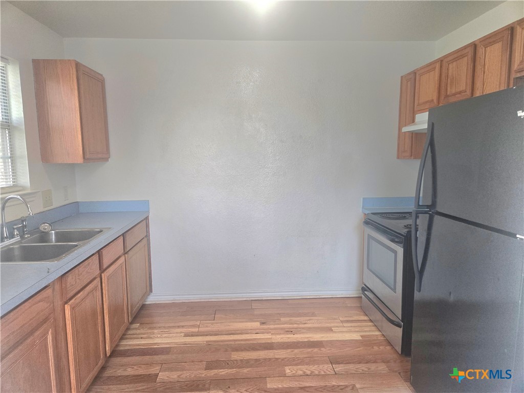 819 South 16th Street Temple, TX 76501 - Photo 2 of 7 a kitchen with stainless steel appliances granite countertop a refrigerator and a sink
