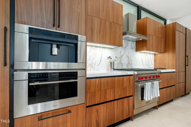 a kitchen with stainless steel appliances granite countertop a stove microwave and cabinets