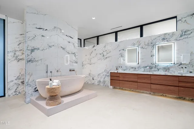 a bathroom with a bathtub sink and mirror