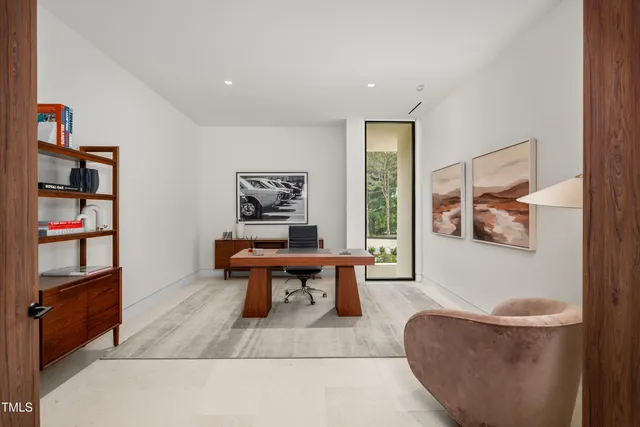 a living room with furniture and a book shelf