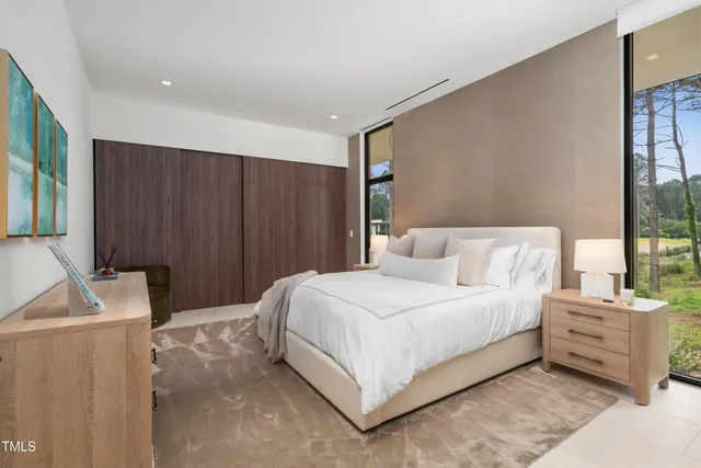 a bedroom with a bed and a night stand