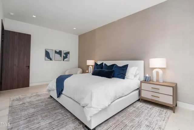 a bedroom with bed and a large window