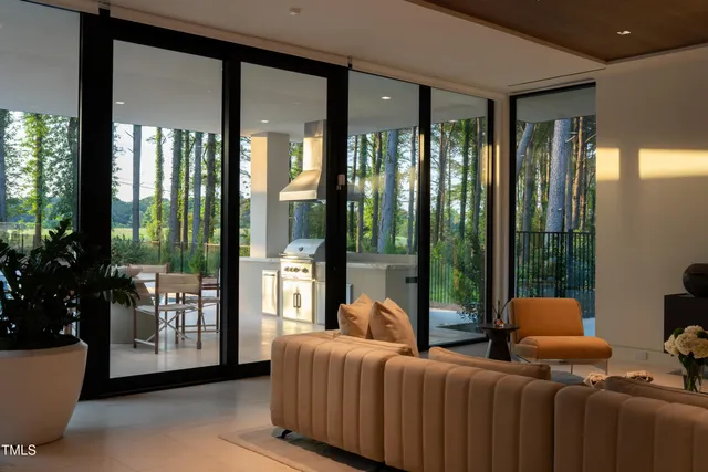 a bedroom with furniture and large windows