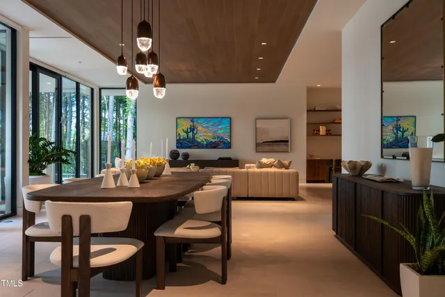 a dining room with furniture a chandelier and window