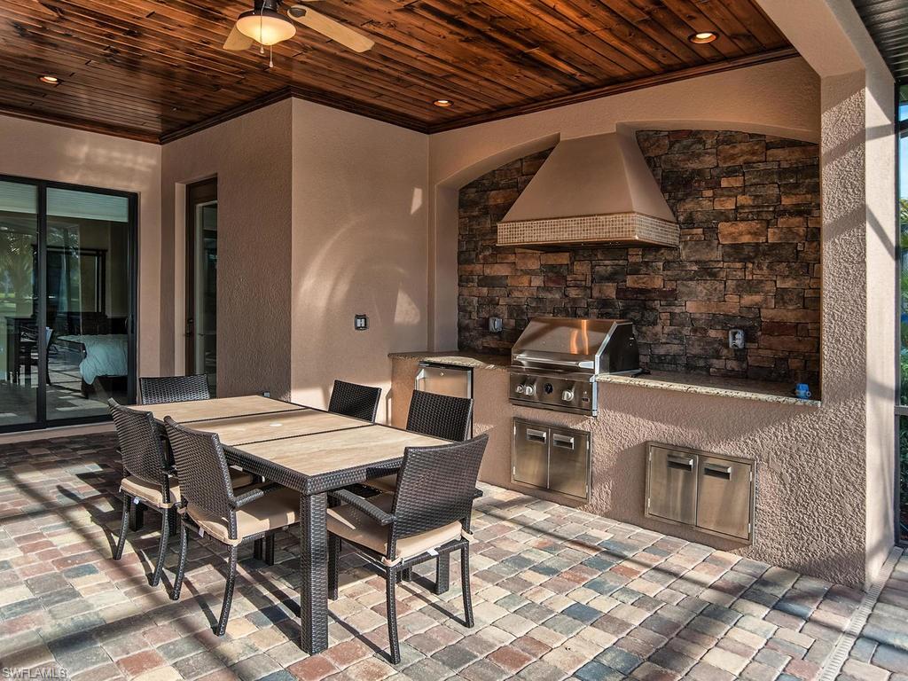 9634 Firenze Circle Naples, FL 34113 - Photo 25 of 35 a outdoor dining space with furniture and stove