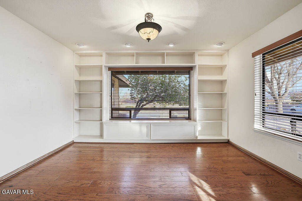 711 Lisa Street Palmdale, CA 93551 - Photo 27 of 66 a view of empty room with wooden floor and fan