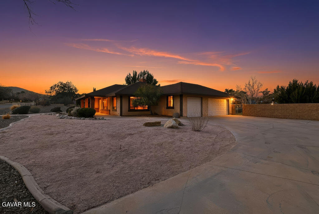 711 Lisa Street Palmdale, CA 93551 - Photo 56 of 66 a view of a house with a yard and a large tree