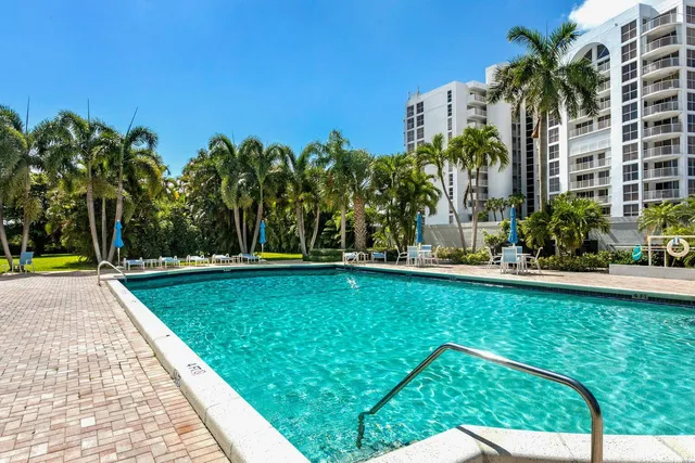 a view of a swimming pool and a yard