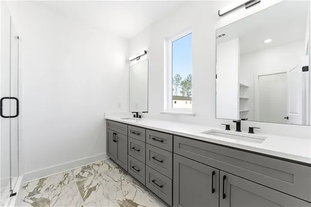 a bathroom with a double vanity sink and a mirror