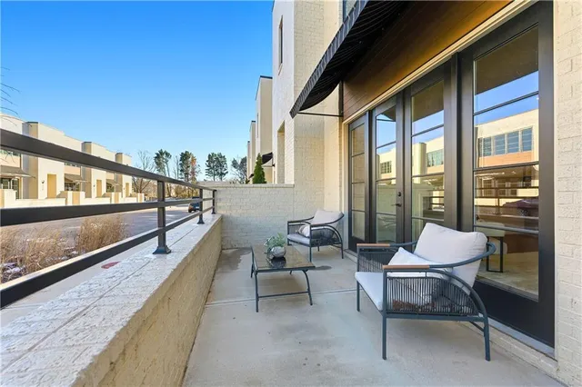 a balcony with chairs and with table