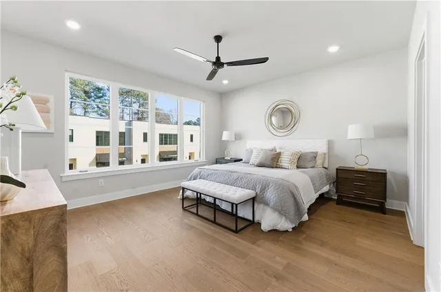 a bedroom with a bed mirror and window