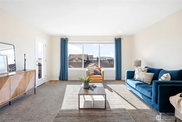 a living room with furniture and large windows