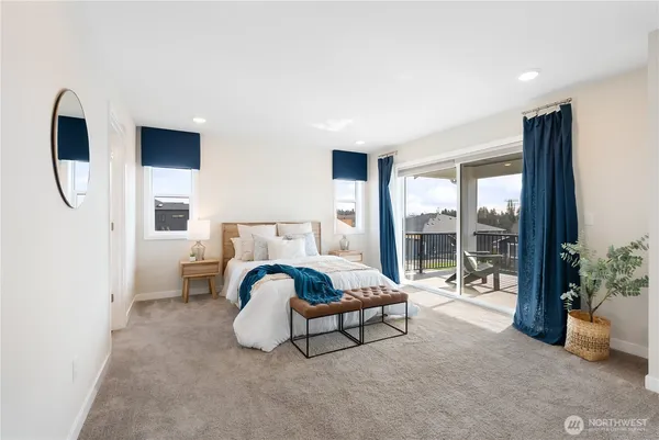 a spacious bedroom with a bed and glass door