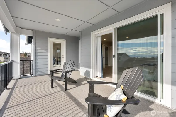 a view of balcony with two chairs and a table