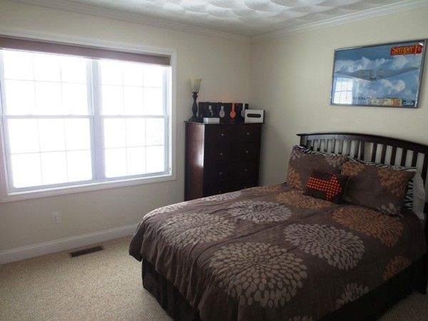 5 Wilbur Road Lincoln, RI 02865 - Photo 19 of 30 a bed sitting in a bedroom next to a window