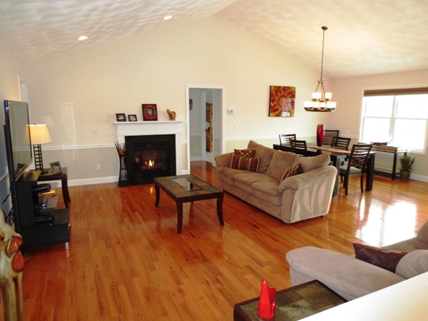 5 Wilbur Road Lincoln, RI 02865 - Photo 4 of 30 a living room with furniture dining table and a fireplace
