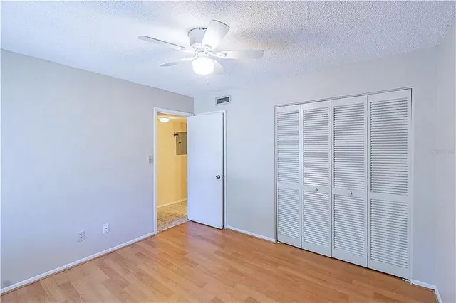 a view of an empty room with a fan