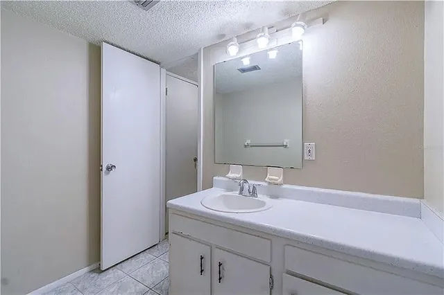 a bathroom with a sink a vanity and a mirror