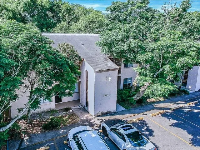 an aerial view of a house with a yard