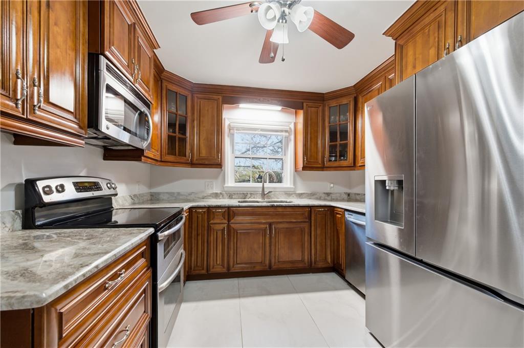 1102 Moorestown Circle Decatur, GA 30033 - Photo 4 of 13 a kitchen with stainless steel appliances granite countertop a sink and a refrigerator