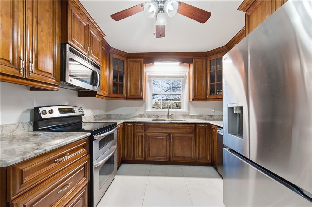 1102 Moorestown Circle Decatur, GA 30033 - Photo 5 of 13 a kitchen with stainless steel appliances granite countertop a refrigerator and a sink