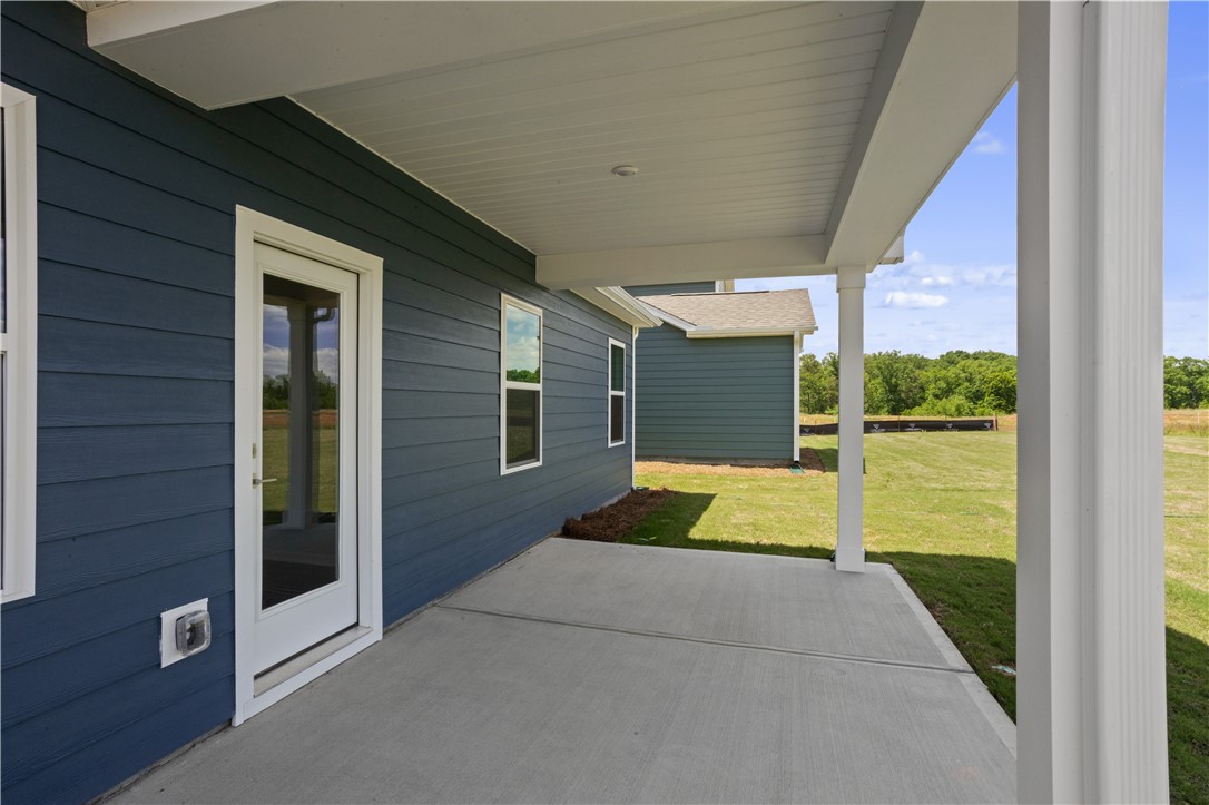 552 Hydrangea Street, Unit LOT 66 Seneca, SC 29678 - Photo 30 of 31 A spacious covered patio invites outdoor enjoyment with a peaceful view of the green landscape.