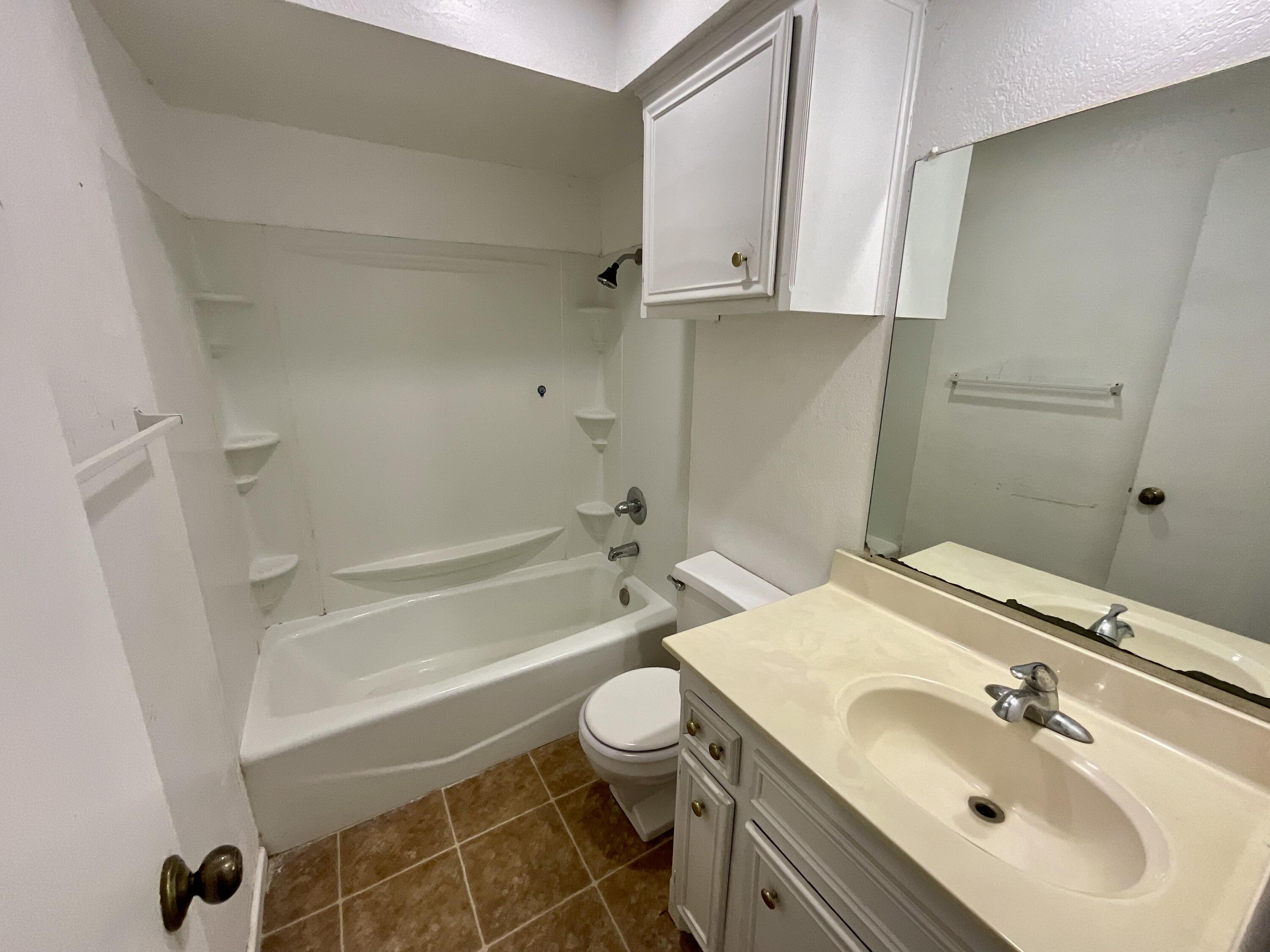 6108 37th Street, Unit B Lubbock, TX 79407 - Photo 8 of 8 a bathroom with a sink toilet vanity and tub