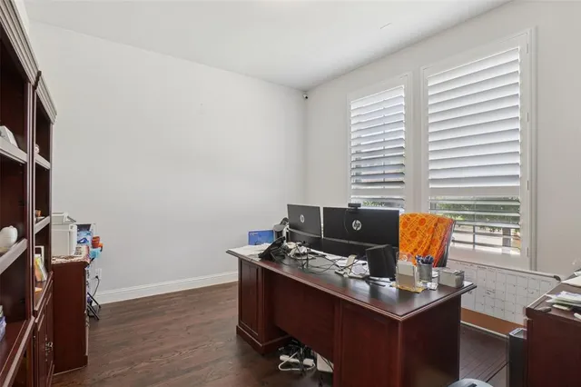 a view of workspace with wooden floor windows