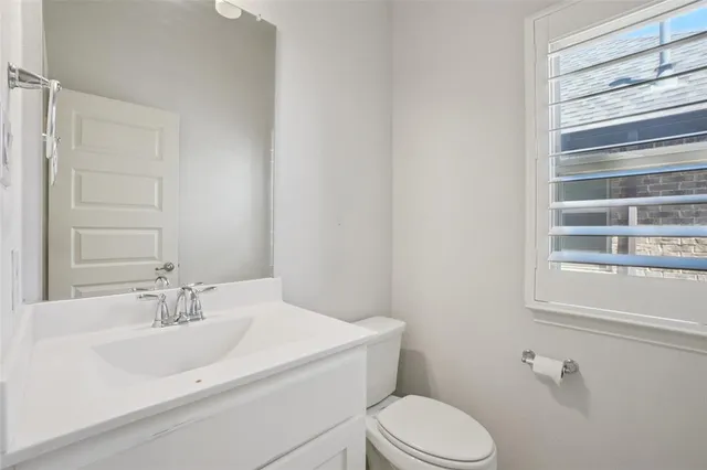 a bathroom with a sink toilet and vanity
