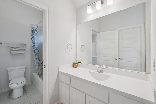 a bathroom with a toilet a sink a mirror and shower