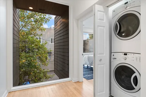 a living room with furniture a window and a potted plant