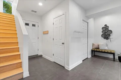 a large white kitchen with a table and chairs