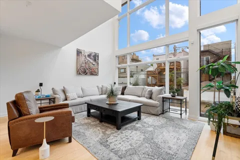 a living room with furniture and a potted plant