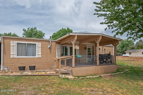 a view of house with yard and entertaining space