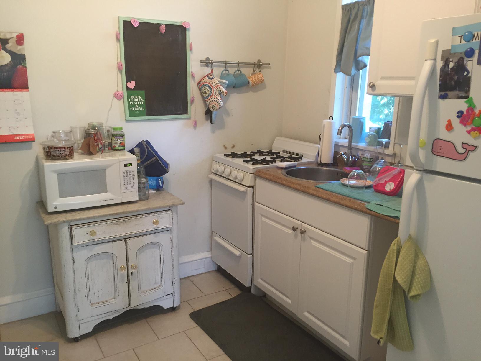 100 South Valley Road, Unit 1A Paoli, PA 19301 - Photo 5 of 11 a kitchen with a stove and cabinets
