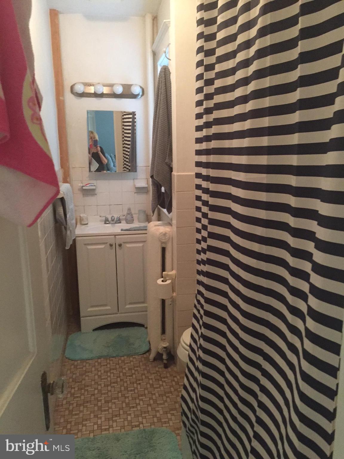 100 South Valley Road, Unit 1A Paoli, PA 19301 - Photo 8 of 11 a bathroom with a sink and a mirror