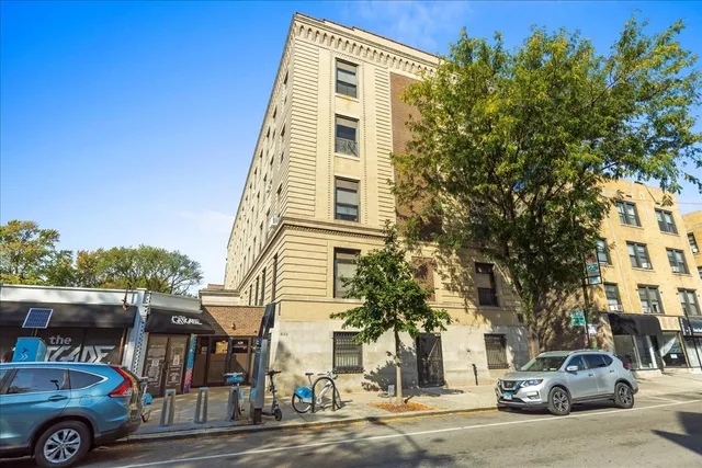 a front view of a residential apartment building with a yard