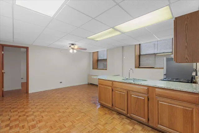 a kitchen with sink and cabinets